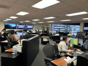 A group of people sitting at desks in an office.